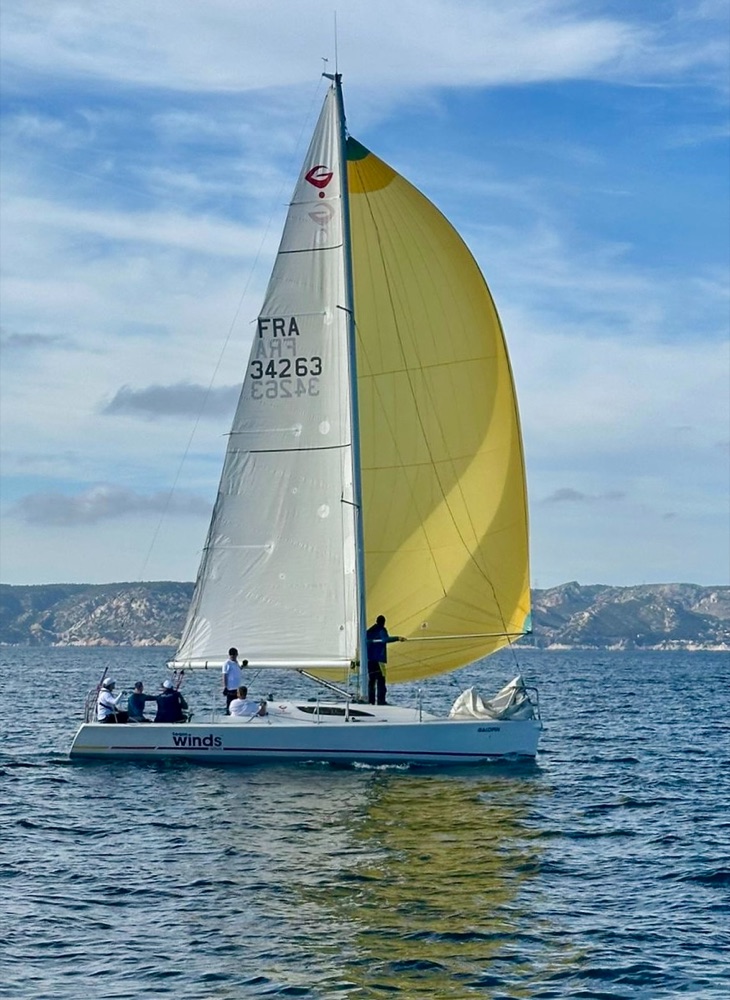 A Grand Surprise sailing with a yellow spinnaker